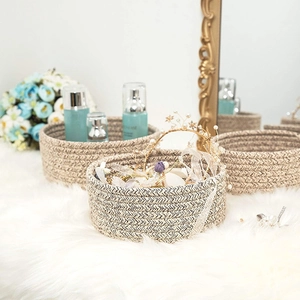 Detail of woven cotton rope storage baskets with herringbone texture on faux fur