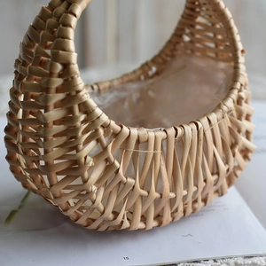Detail of hand-woven wicker basket featuring a waterproof plastic liner for floral arrangements
