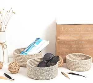 Three-piece set of woven cotton rope baskets in cream and brown for home organization