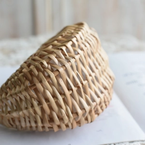 Close-up of woven wicker flower basket with detailed natural willow texture and arc shape