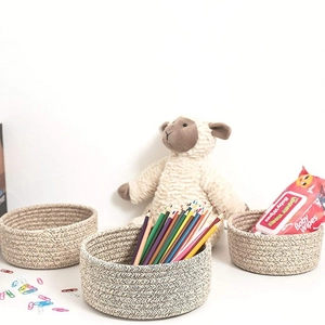 Three-piece set of woven cotton rope storage baskets in natural beige and grey tones