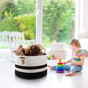 Close-up of extra large black and white striped woven cotton rope basket in a nursery room