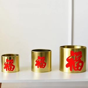 Detailed view of three sizes of golden metal buckets featuring red Fu characters