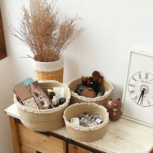 Detail of round cotton linen storage baskets with elegant white lace trim for home decor