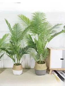 Detail of a two-tone woven basket with artificial green palm leaves in a home setting