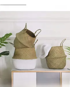 Detail of woven seagrass basket with white coating and round handles for home storage