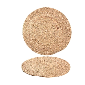 Set of two round handmade natural straw placemats with woven heat insulation design