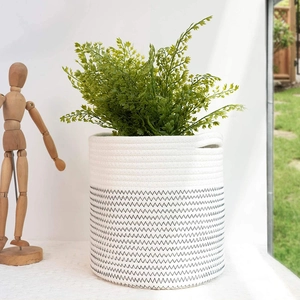 White woven cotton rope plant basket with black zigzag pattern and built-in handles