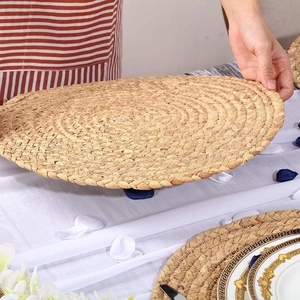 Handmade woven circular heat resistant placemat made from natural seagrass and corn husk