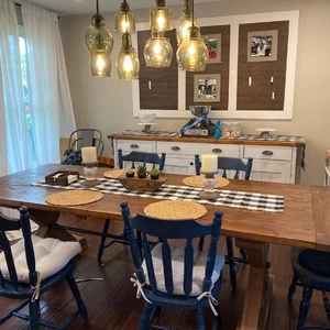 Handmade woven heat-resistant mats on a farmhouse dining table with Windsor chairs