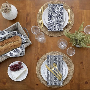 Detailed close-up of blue floral paisley and striped patterns on linen napkins