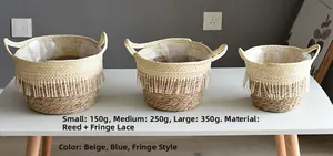 Three-piece seagrass woven basket set with white tassel trim and waterproof plastic liners
