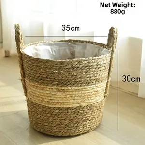 Detail of woven seagrass plant basket with dual handles and protective plastic liner