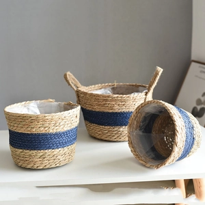 Three-piece set of woven seagrass planters with waterproof liners and blue accents