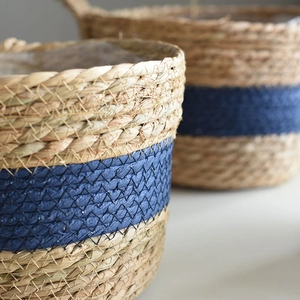 Detail of hand-woven seagrass planter with blue stripe and waterproof plastic liner