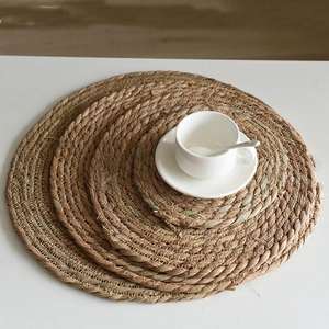 Detail of round woven seagrass coasters showing natural texture and heat resistance