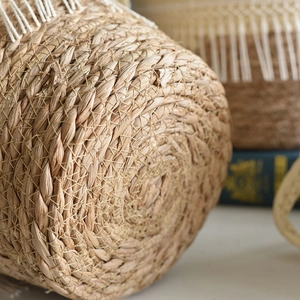 Handcrafted round seagrass planter basket with natural spiral woven texture detail