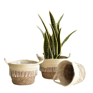 Handwoven seagrass plant baskets with fringe details and waterproof liners in three sizes