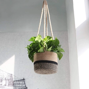 Handwoven hemp rope hanging basket for plants with black and white woven pattern