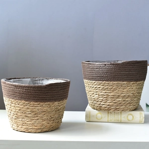 Set of two woven grass plant pots with waterproof liners for modern home decor