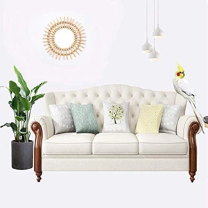 Detail view of American classic tufted fabric sofa with solid wood frame and decorative pillows