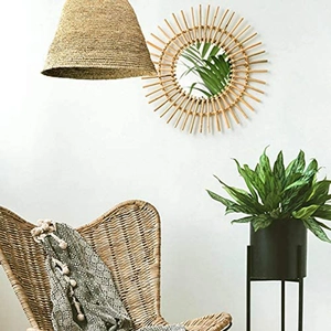 Detailed view of sunburst rattan wall mirror with natural woven textures in a modern room