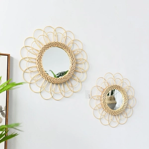 Detail of handcrafted rattan wall mirrors with woven petal edges in bohemian style