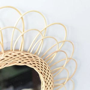 Macro shot showing detailed hand-woven natural rattan texture on bohemian wall mirror