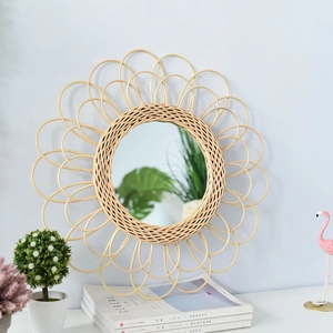 Detail of bohemian round rattan flower-shaped wall mirror with natural woven petals