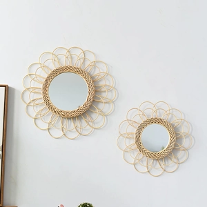 Detail of handmade bohemian rattan wall mirrors with natural sunburst woven petal design