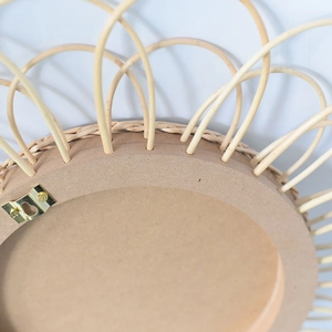 Detail of the MDF backboard and sturdy golden metal wall mounting hook on the woven mirror