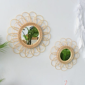 Detail of sunflower shape woven rattan wall mirror with natural petal texture in boho style