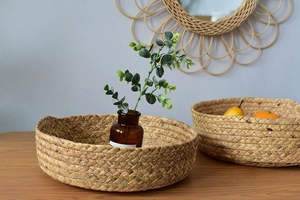 Detail of two-piece round woven seagrass trays for home organization and fruit storage