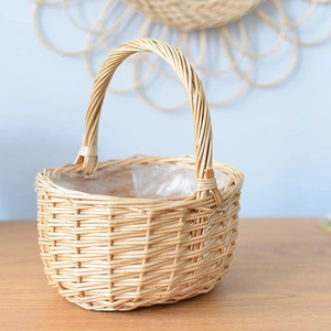 Detail view of natural woven flower basket with waterproof plastic lining and arched handle