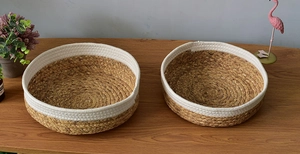 Close-up of woven seagrass storage baskets with a two-tone natural and white design