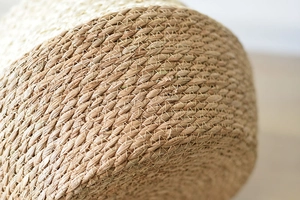 Detailed close-up of handmade woven plant basket showing two-tone fiber texture and craftsmanship