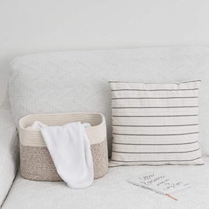 Detailed macro view of dual-color woven cotton rope basket for home organization