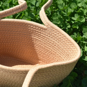 Beige cotton rope woven tote bag handcrafted for women shown on green grass background