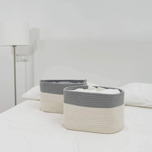 Close-up of woven cotton rope storage baskets with grey and white two-tone minimalist design
