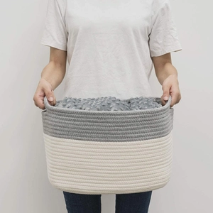 Close-up of woven cotton rope basket in grey and white with soft inner blanket