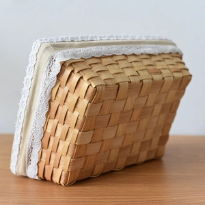 Square woven storage basket with beige linen liner and delicate white lace trim