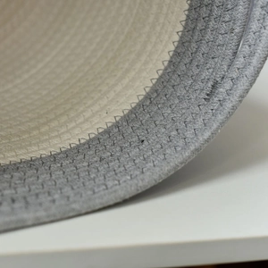 Close-up of dual-color cotton rope weaving with precise zigzag stitching detail