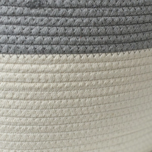 Macro shot of the two-tone gray and white cotton rope basket with zigzag stitching