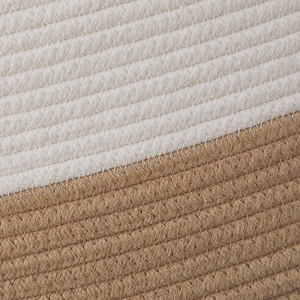 Macro detail of hand-woven cotton rope storage basket featuring dual-tone stitching texture
