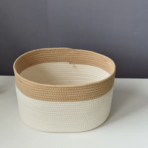 Macro shot of cotton rope woven storage basket with dual-tone texture and neat stitching
