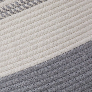 Close-up detail of grey and white cotton rope weave on a durable storage basket