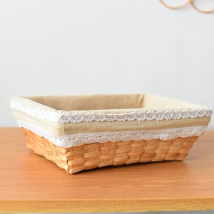 Detailed view of woven rectangular basket featuring a lace-trimmed cotton linen lining
