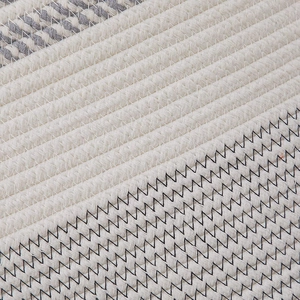 Macro shot of cotton rope weave with grey stripes and black zigzag decorative stitching