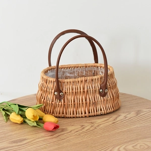 Detail of woven wicker basket with brown leather handles and waterproof plastic lining