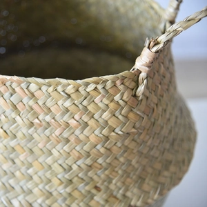 Close-up of hand-woven seagrass basket showing tight twill texture and sturdy handle